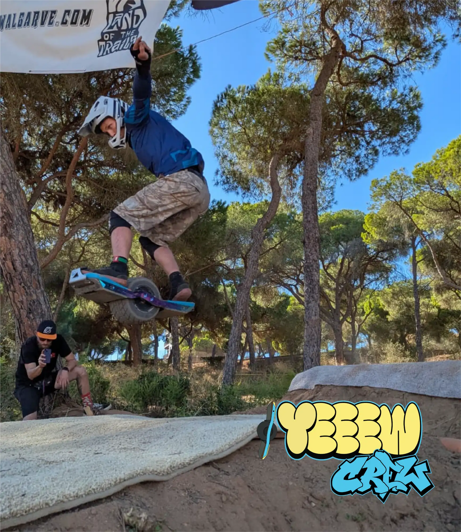 Blue and purple unicycle with a single wheel, rider wearing protective gear